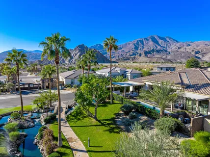 a view of a house with swimming pool and sitting area