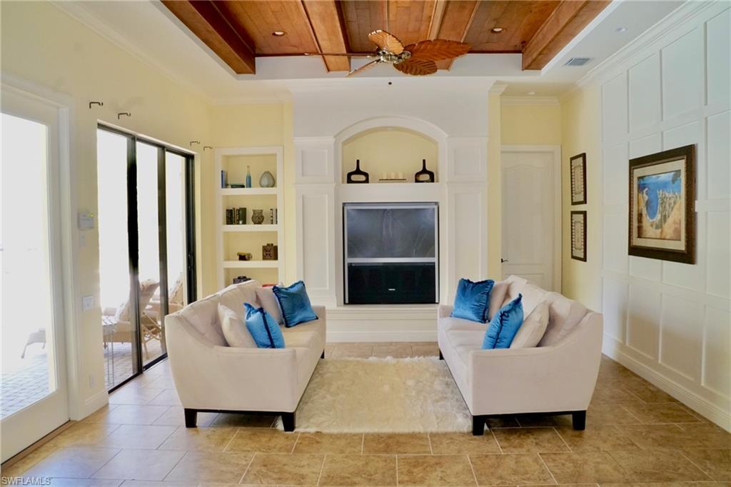 4231 Pine Ridge Road Naples, FL 34119 - Photo 5 of 18 a living room with furniture and a fireplace