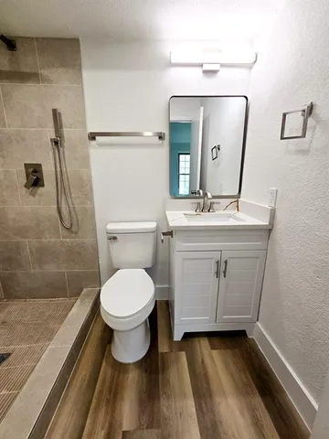 a bathroom with a sink toilet and shower