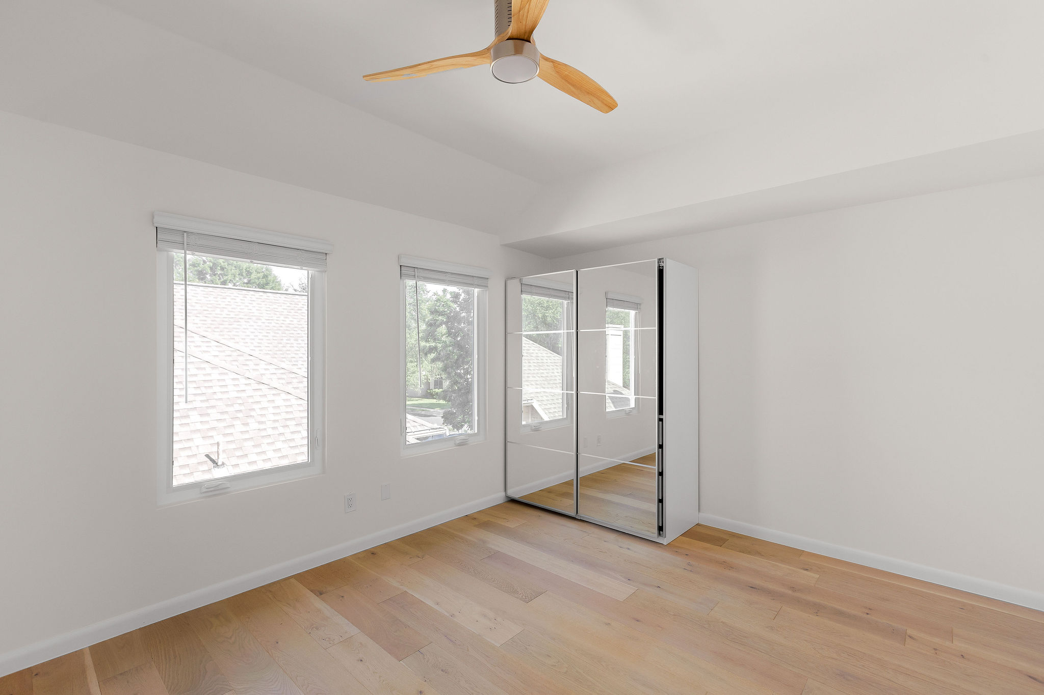 6500 Clay Allison Pass Austin, TX 78749 - Photo 29 of 39 Spacious room featuring light wood-finish flooring, a contemporary ceiling fan, dual windows with blinds, and white walls