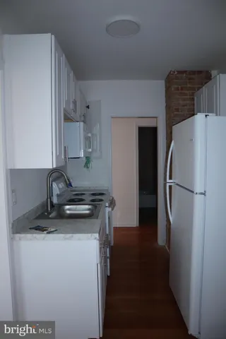 a kitchen with a refrigerator and a stove