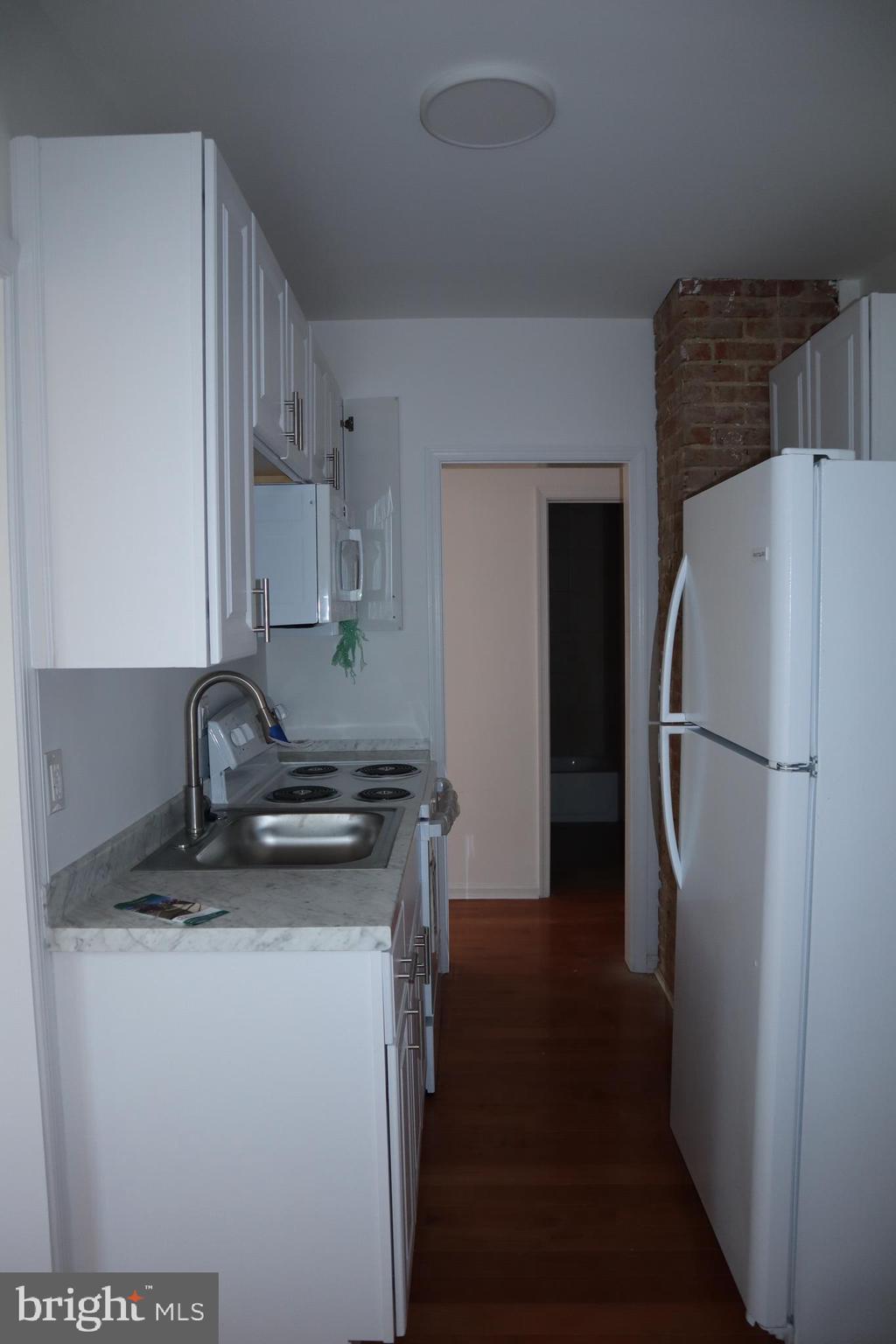 1004 Shepherd Street Northeast Washington, DC 20017 - Photo 11 of 28 a kitchen with a refrigerator and a stove