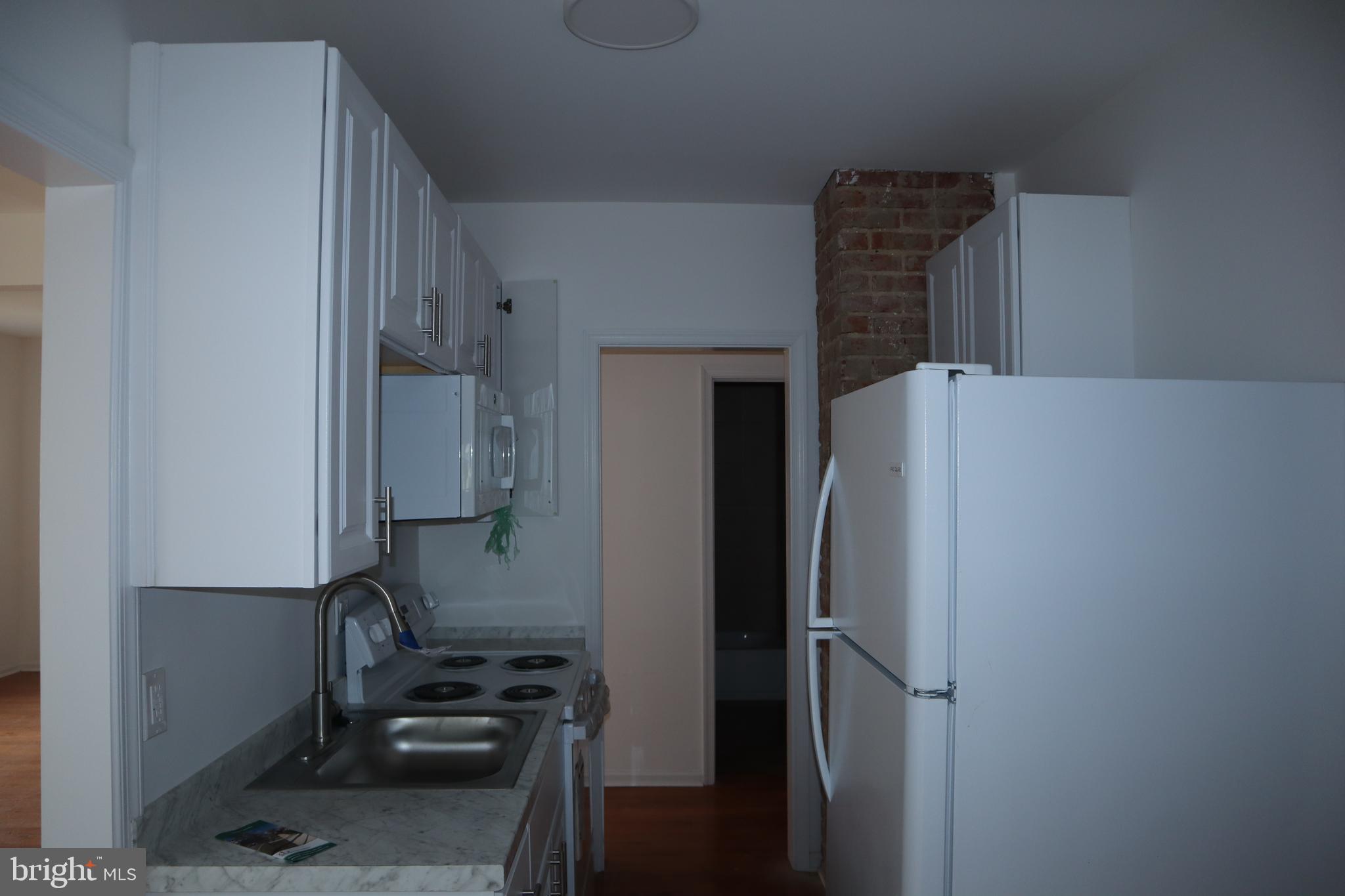 1004 Shepherd Street Northeast Washington, DC 20017 - Photo 12 of 28 a kitchen with a refrigerator and a stove top oven