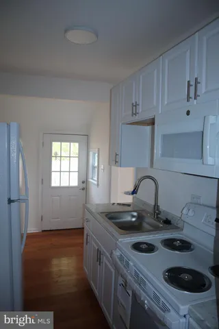 a kitchen with a stove and a refrigerator