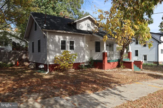 a view of a house with a yard patio and a tree