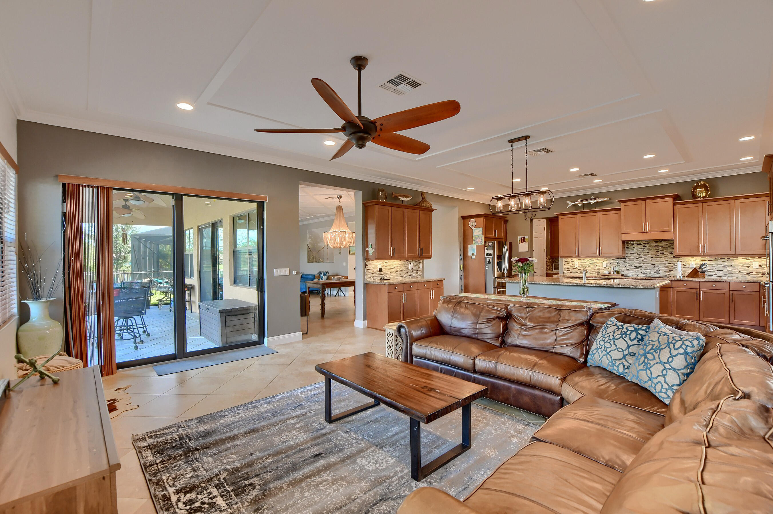 12161 Boca Reserve Lane Boca Raton, FL 33428 - Photo 18 of 53 a living room with furniture a ceiling fan and a rug