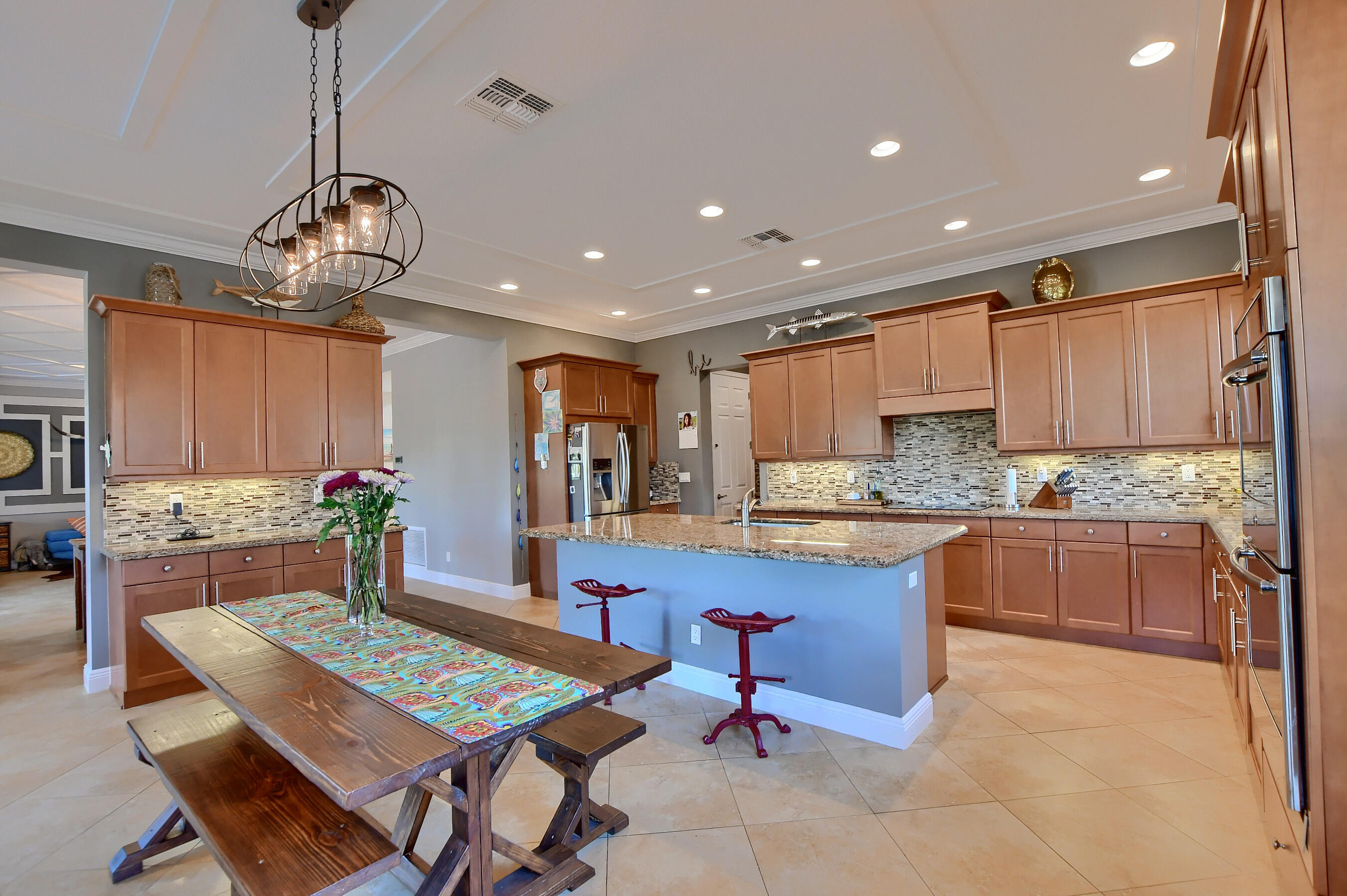 12161 Boca Reserve Lane Boca Raton, FL 33428 - Photo 19 of 53 a large kitchen with a table and chairs in it
