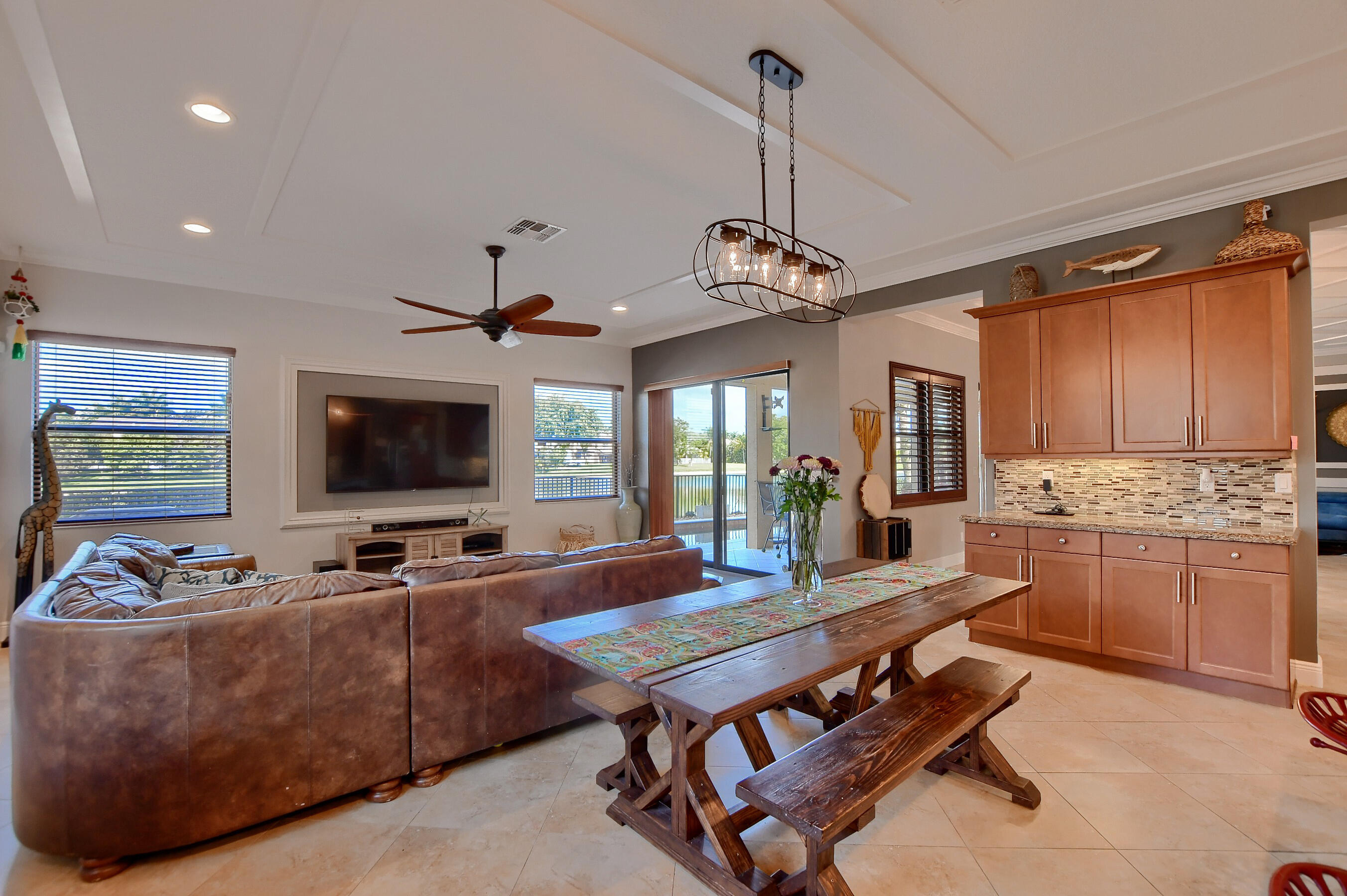 12161 Boca Reserve Lane Boca Raton, FL 33428 - Photo 25 of 53 a living room with furniture kitchen view and a flat screen tv