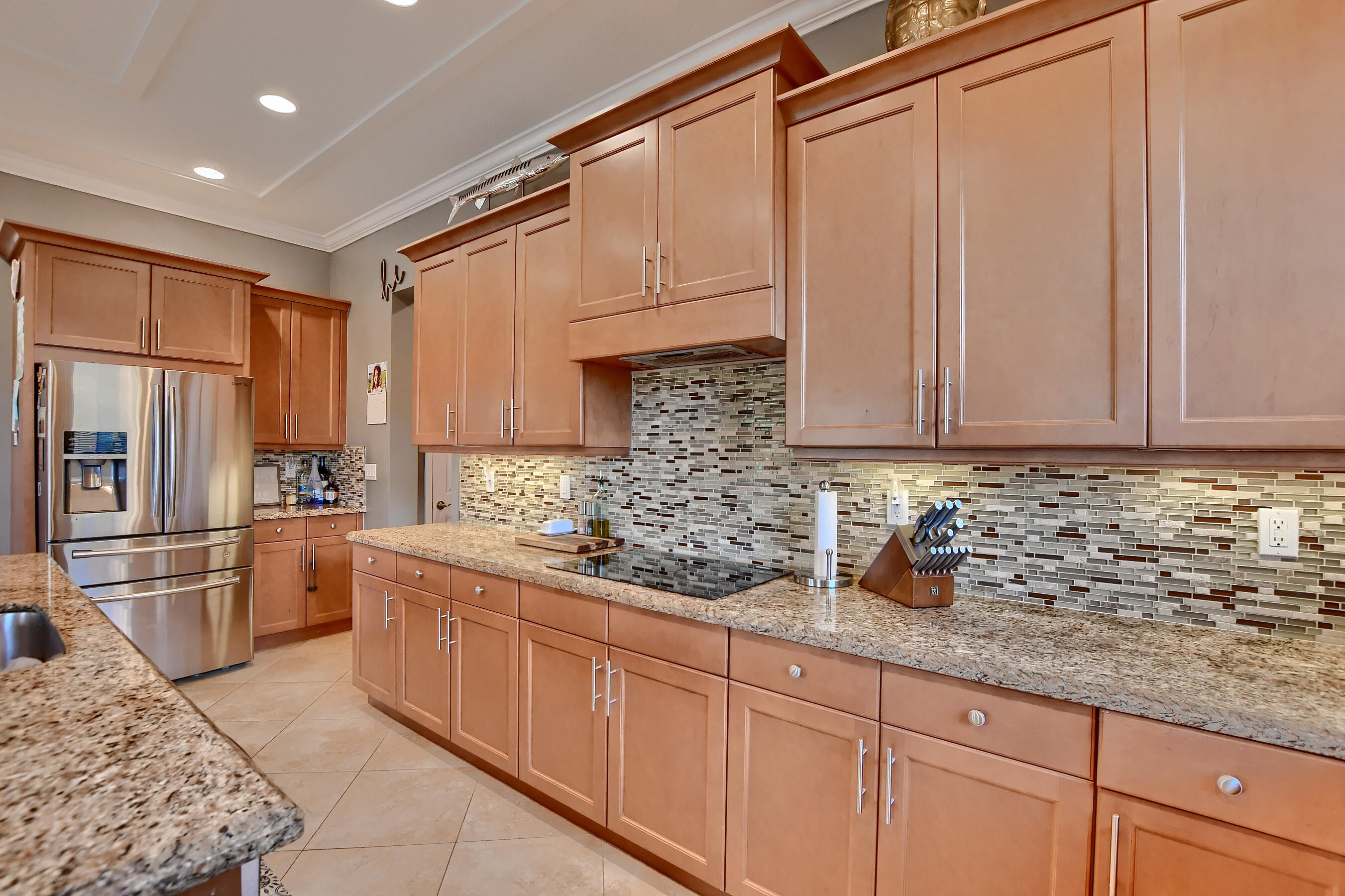12161 Boca Reserve Lane Boca Raton, FL 33428 - Photo 27 of 53 a kitchen with stainless steel appliances granite countertop a sink a stove a refrigerator and cabinets