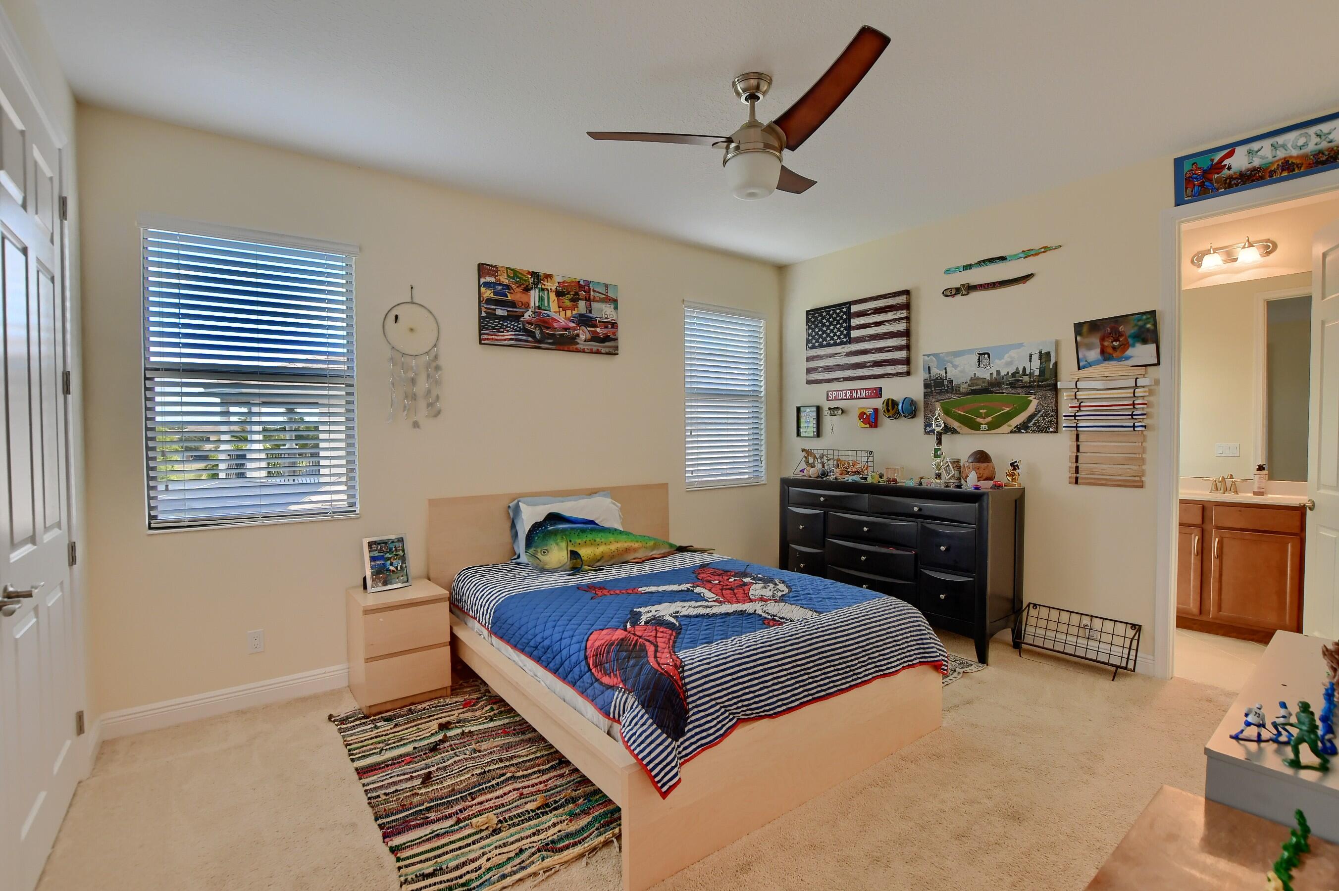 12161 Boca Reserve Lane Boca Raton, FL 33428 - Photo 34 of 53 a bedroom with a bed and a dresser