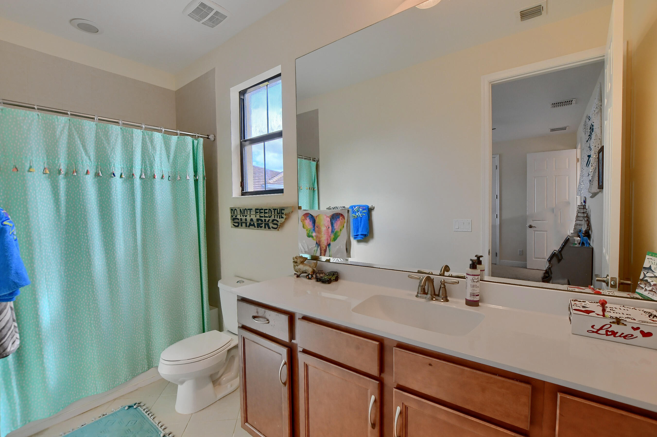12161 Boca Reserve Lane Boca Raton, FL 33428 - Photo 36 of 53 a bathroom with a sink a toilet and mirror
