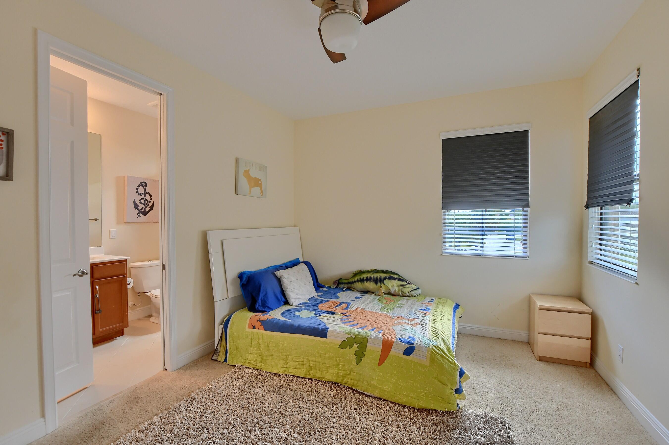 12161 Boca Reserve Lane Boca Raton, FL 33428 - Photo 37 of 53 a bedroom with a bed and wooden floor