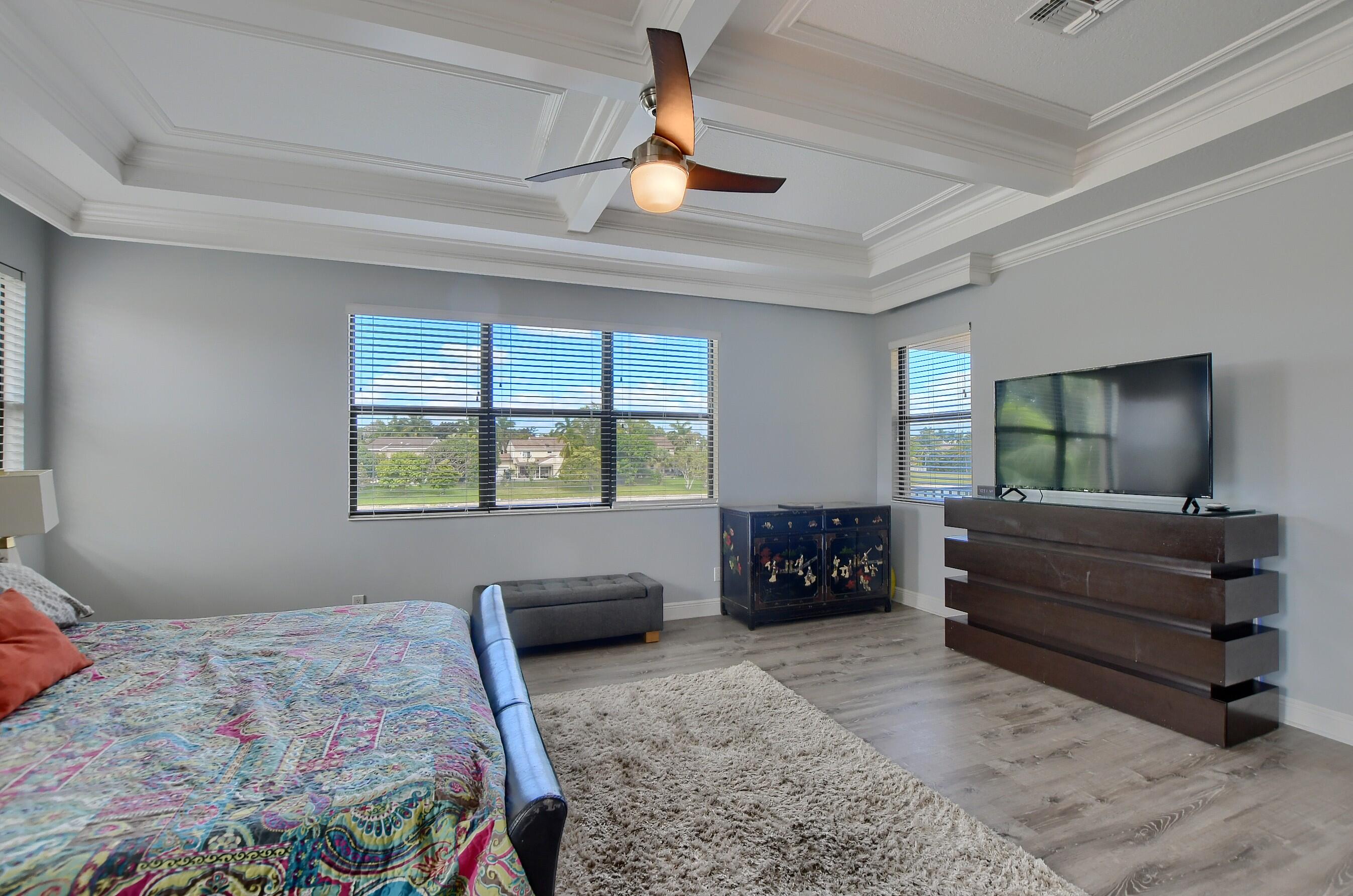 12161 Boca Reserve Lane Boca Raton, FL 33428 - Photo 42 of 53 a bedroom with a bed and a dresser