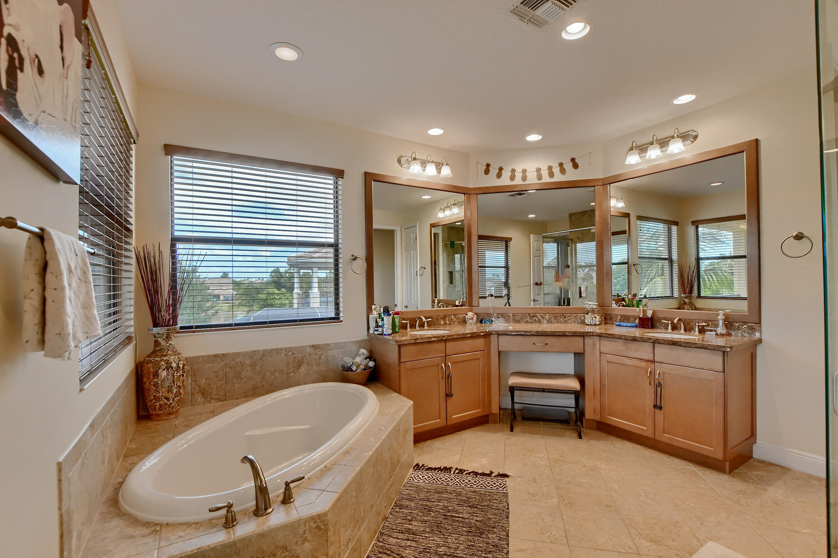 12161 Boca Reserve Lane Boca Raton, FL 33428 - Photo 44 of 53 a bathroom with a tub a sink a mirror and a shower