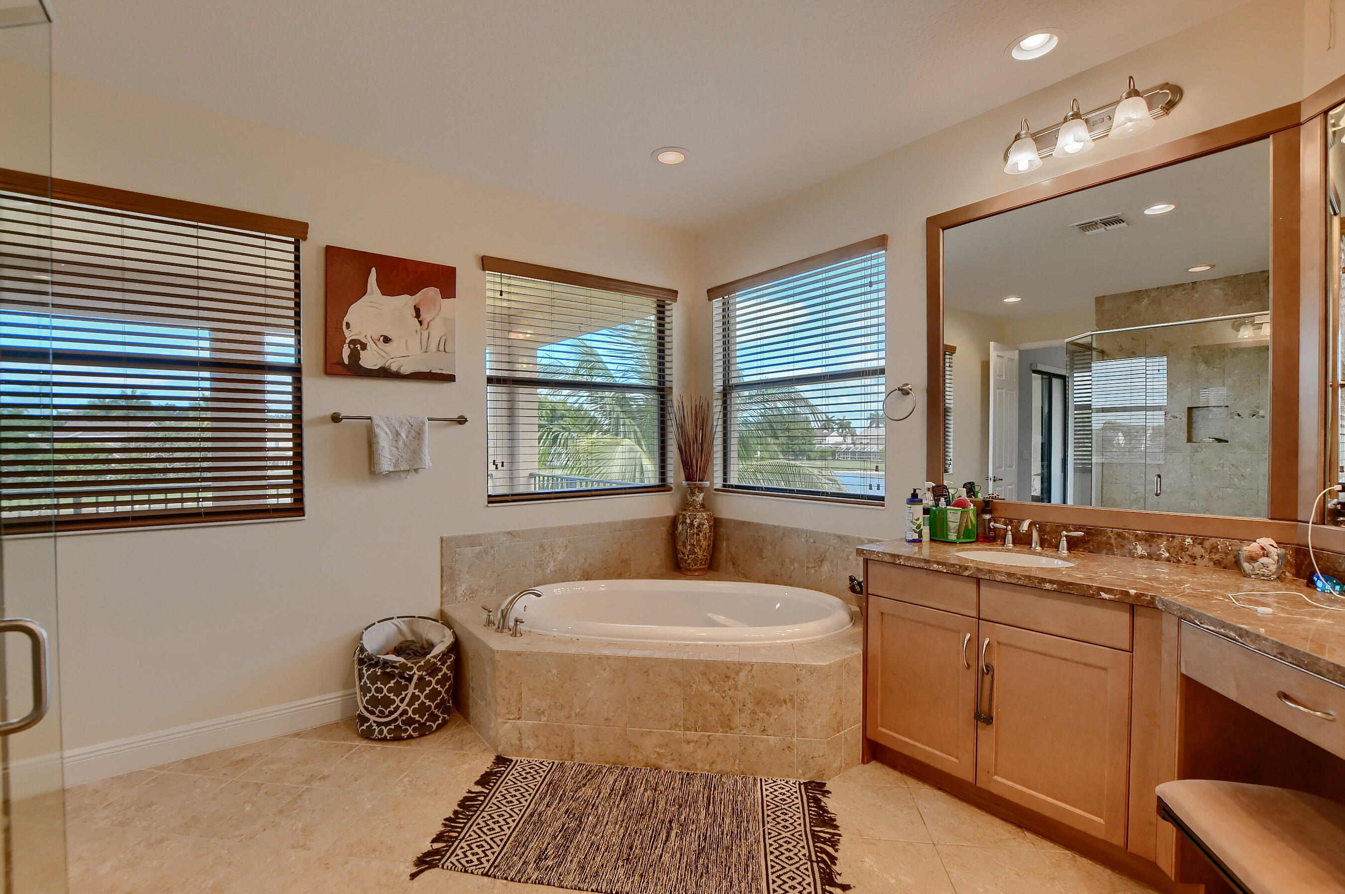 12161 Boca Reserve Lane Boca Raton, FL 33428 - Photo 45 of 53 a bathroom with a double vanity sink a mirror and a bathtub
