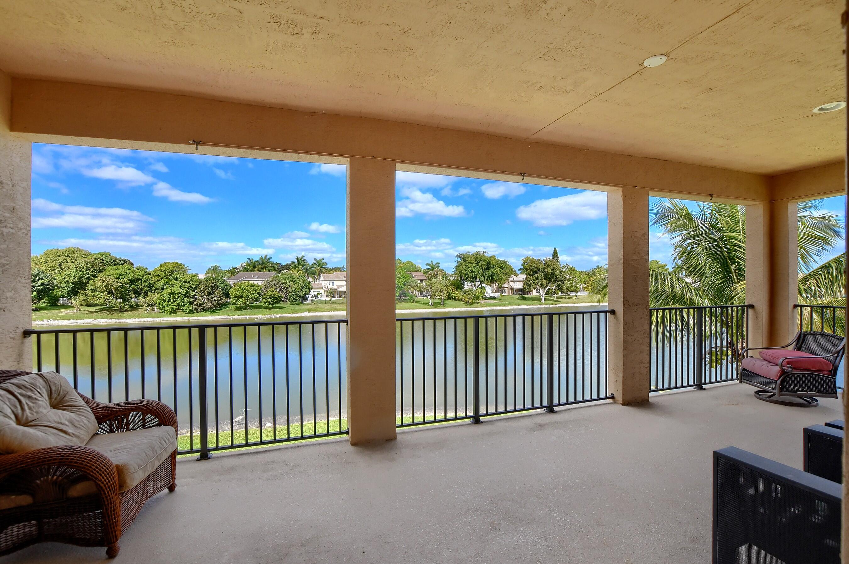 12161 Boca Reserve Lane Boca Raton, FL 33428 - Photo 47 of 53 a balcony with furniture and city view