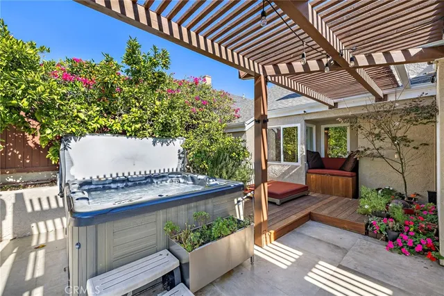a view of a patio with table and chairs potted plants