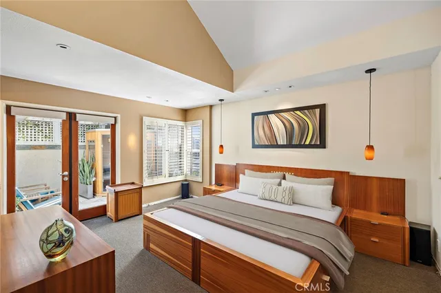 a bedroom with furniture and large window