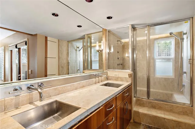 a bathroom with a granite countertop sink and a large mirror