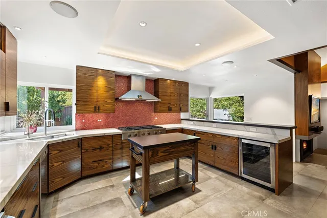 a kitchen that has a sink and a stove in it