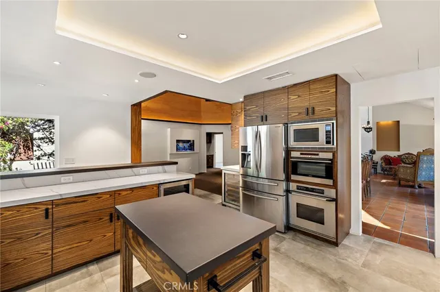 a kitchen with a refrigerator and a sink