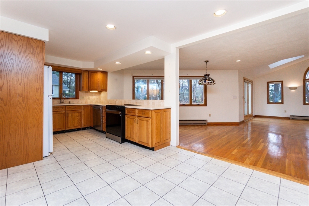 19 Homestead Road Lynnfield, MA 01940 - Photo 13 of 34 a large kitchen with a stove top oven and cabinets