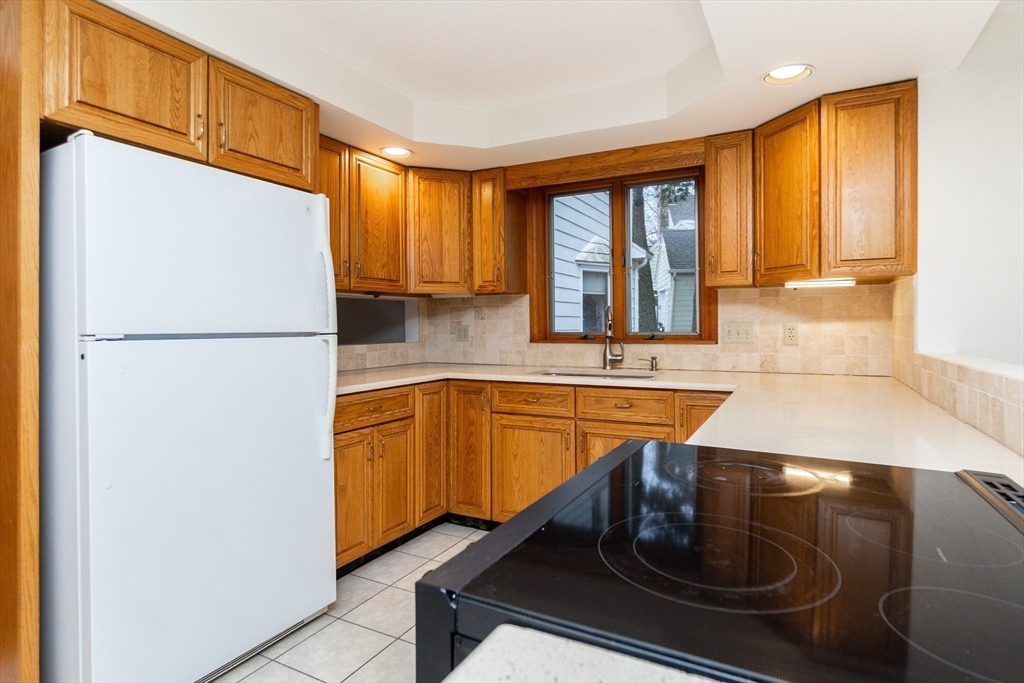 19 Homestead Road Lynnfield, MA 01940 - Photo 15 of 34 a kitchen with stainless steel appliances granite countertop a refrigerator a sink and a stove