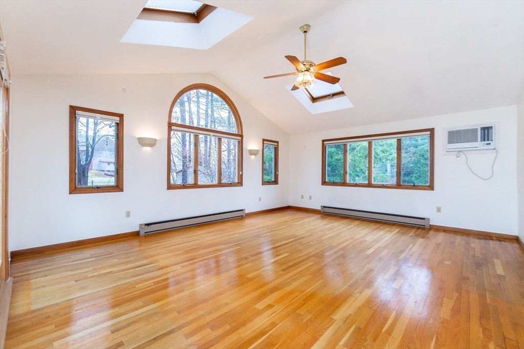 19 Homestead Road Lynnfield, MA 01940 - Photo 19 of 34 a view of an empty room with window and wooden floor