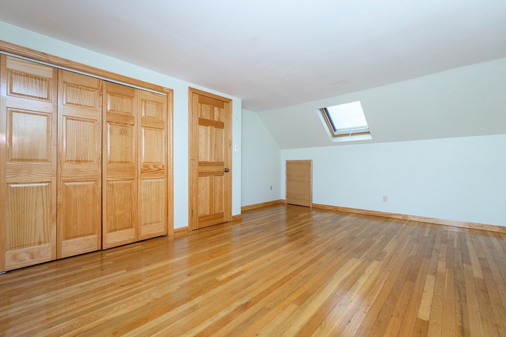 19 Homestead Road Lynnfield, MA 01940 - Photo 24 of 34 a view of an empty room with wooden floor and a window