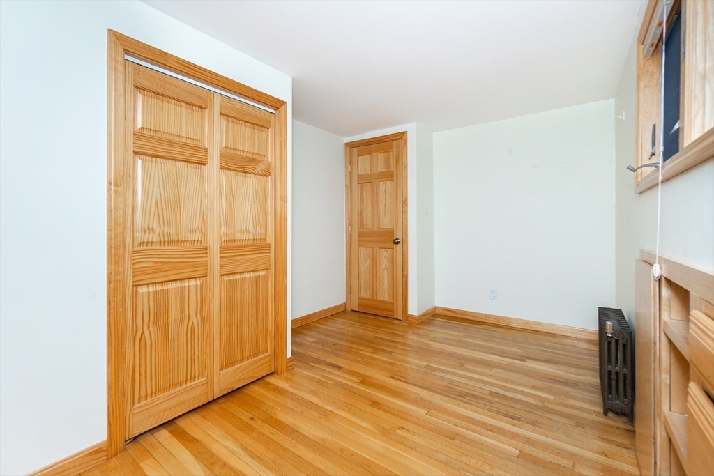 19 Homestead Road Lynnfield, MA 01940 - Photo 26 of 34 a view of an empty room with wooden floor and a window