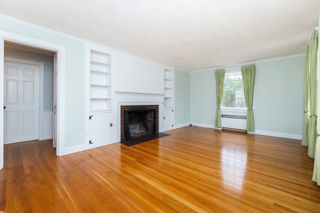 19 Homestead Road Lynnfield, MA 01940 - Photo 3 of 34 a view of empty room with wooden floor and fireplace