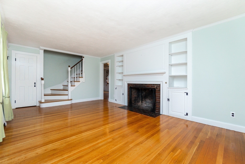 19 Homestead Road Lynnfield, MA 01940 - Photo 5 of 34 a view of empty room with wooden floor and fireplace