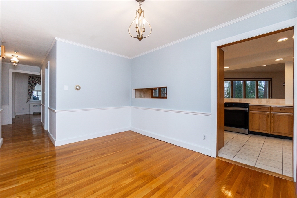 19 Homestead Road Lynnfield, MA 01940 - Photo 8 of 34 a view of a room with wooden floor and kitchen view