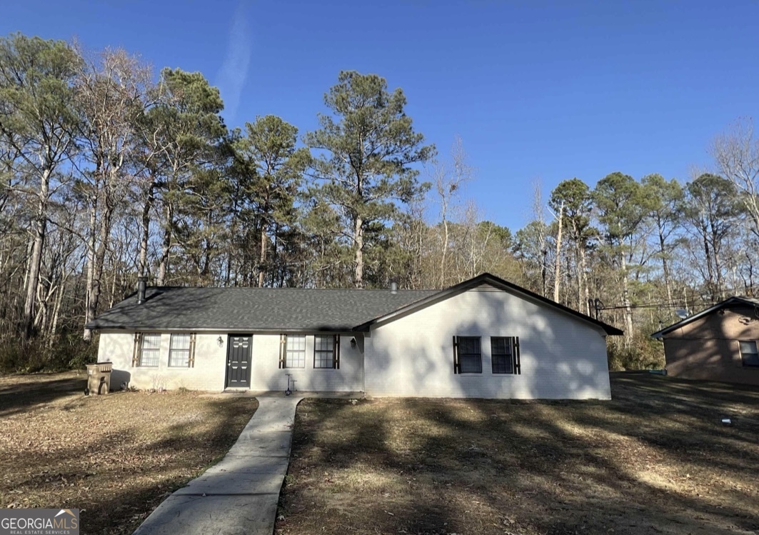 a house with trees in the background