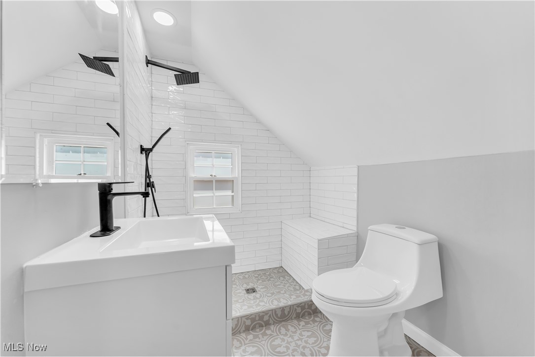 3663 Strathavon Road Cleveland, OH 44120 - Photo 31 of 39 Bathroom featuring tile patterned floors, vaulted ceiling, vanity, and toilet