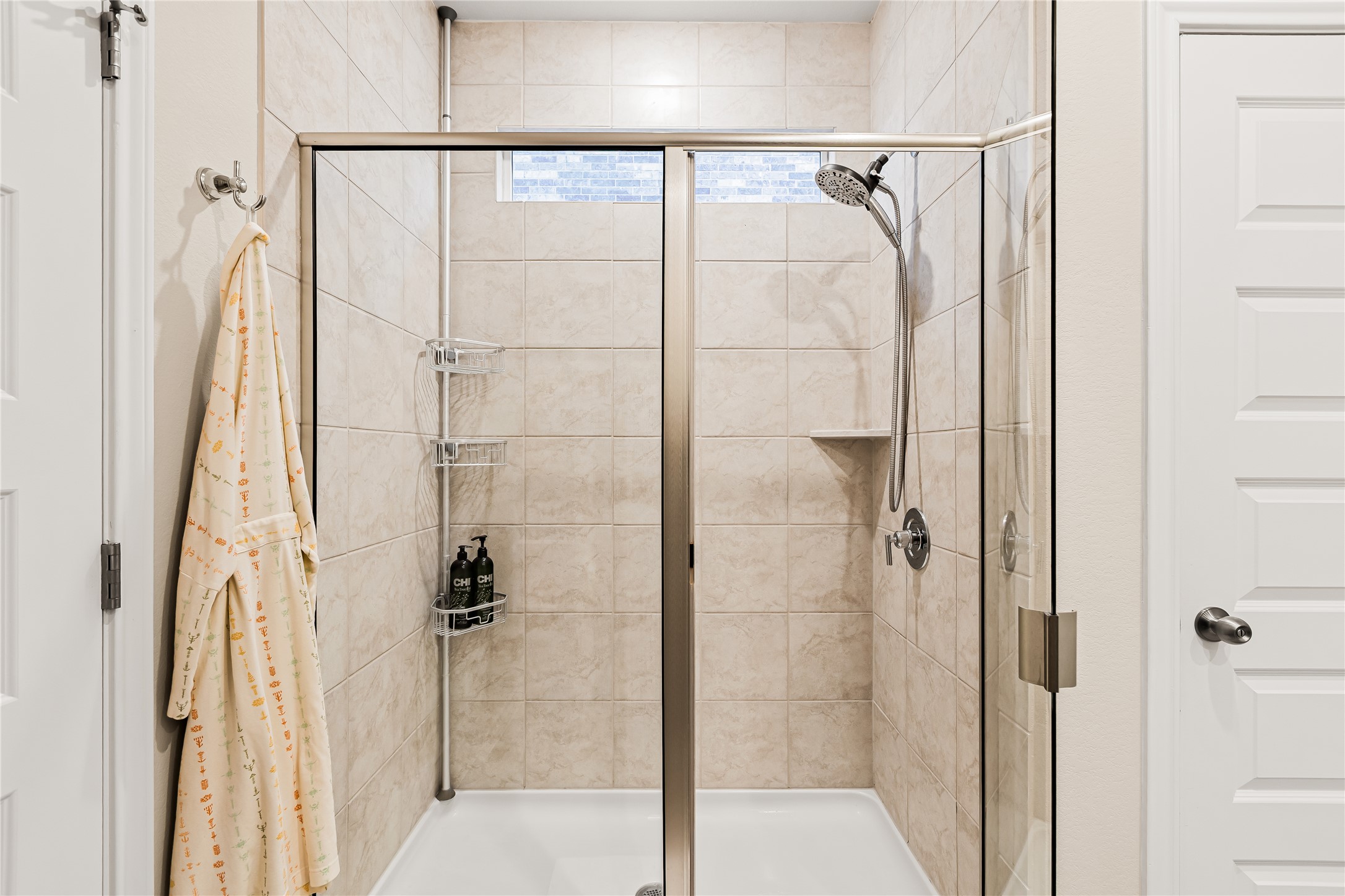 862 Pepperbark Loop Buda, TX 78610 - Photo 20 of 40 a bathroom with a glass shower door