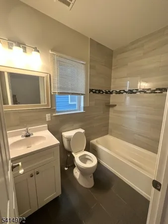 a bathroom with a toilet a sink and bathtub