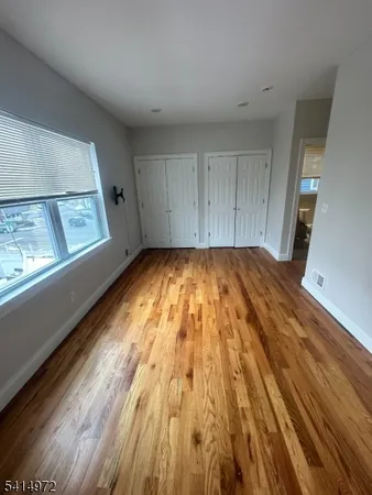 a view of a room with wooden floor and natural light