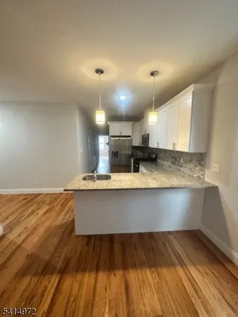 a view of kitchen and wooden floor
