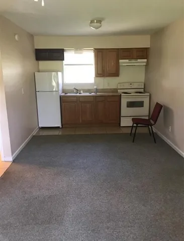 a view of a kitchen with a sink cabinets and a window