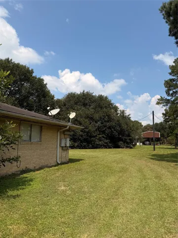a backyard of a house with lots of green space and lake view