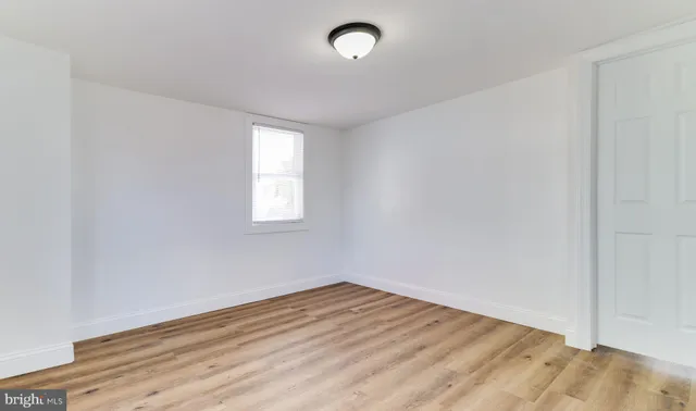 a bathroom with a bathtub a toilet and a window