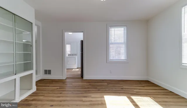 a view of a kitchen with wooden floor and a sink