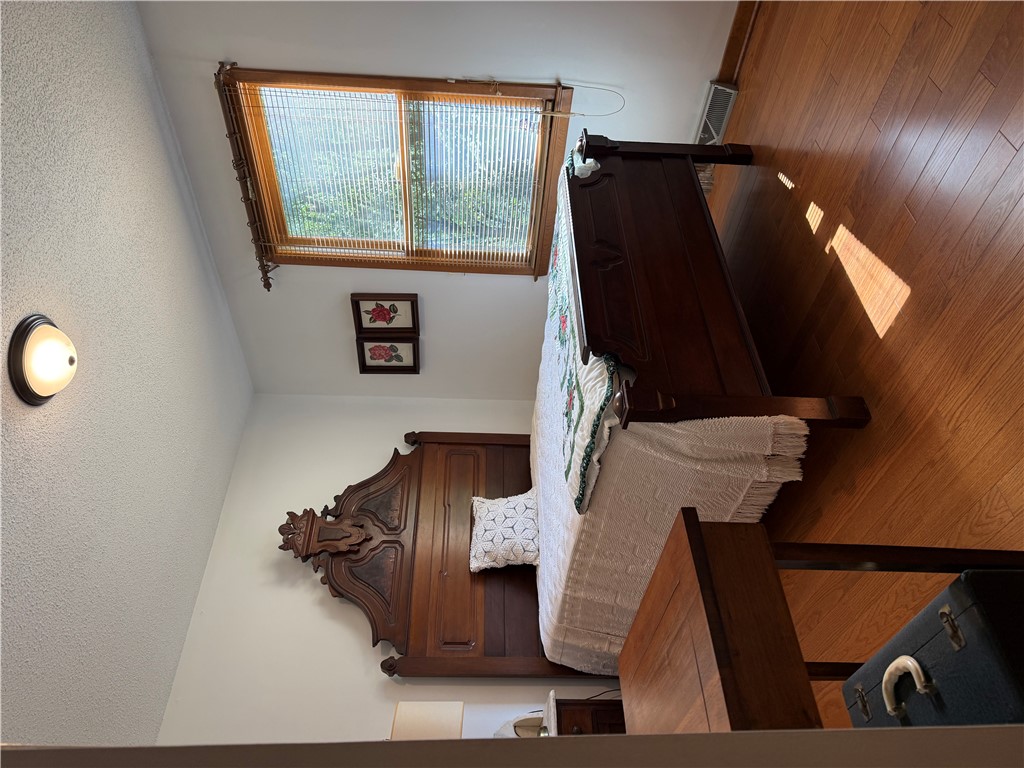 407 Seawright Drive Pendleton, SC 29670 - Photo 14 of 29 Gleaming hardwood floors and a wood-framed window define this quiet bedroom.