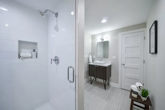 a bathroom with a sink a mirror and a shower