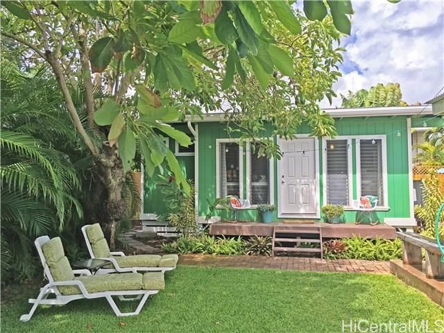 a backyard of a house with table and chairs