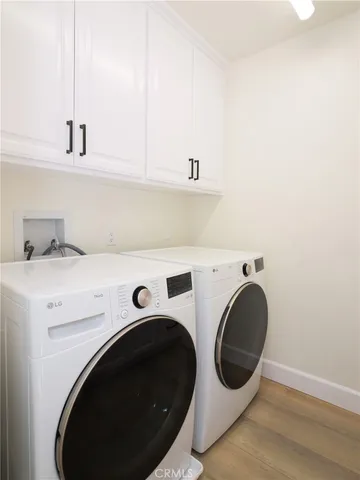 a view of a chandelier fan and wooden floor