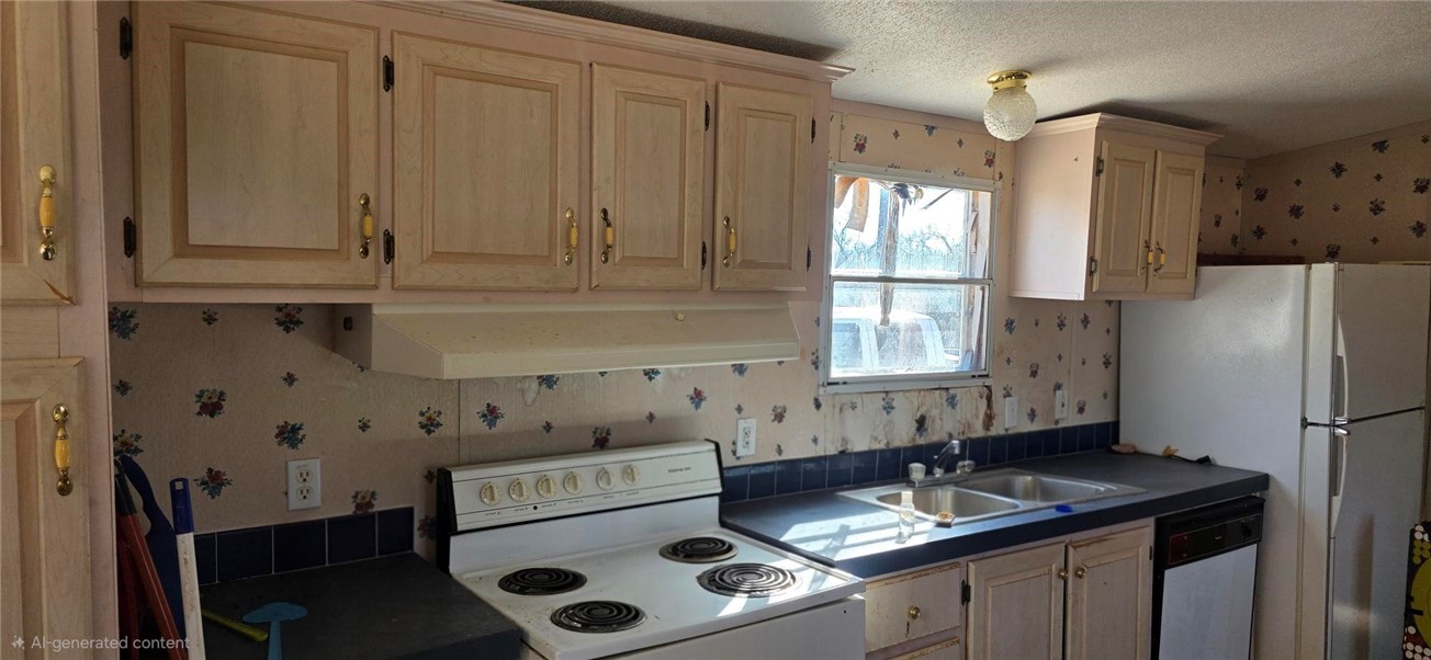 123-124 Frontier Road San Diego, TX 78384 - Photo 7 of 20 a kitchen with granite countertop a sink stove and refrigerator