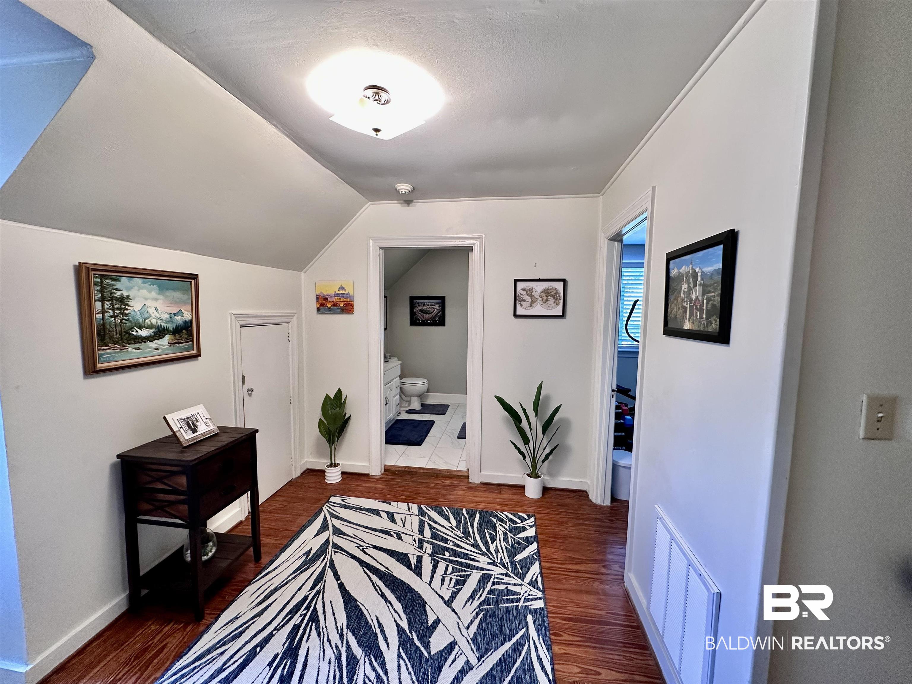 260 Siena Vista Street Mobile, AL 36607 - Photo 29 of 41 Hall featuring wood finished floors, vaulted ceiling, and baseboards