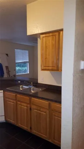 a bathroom with a sink a mirror and a window